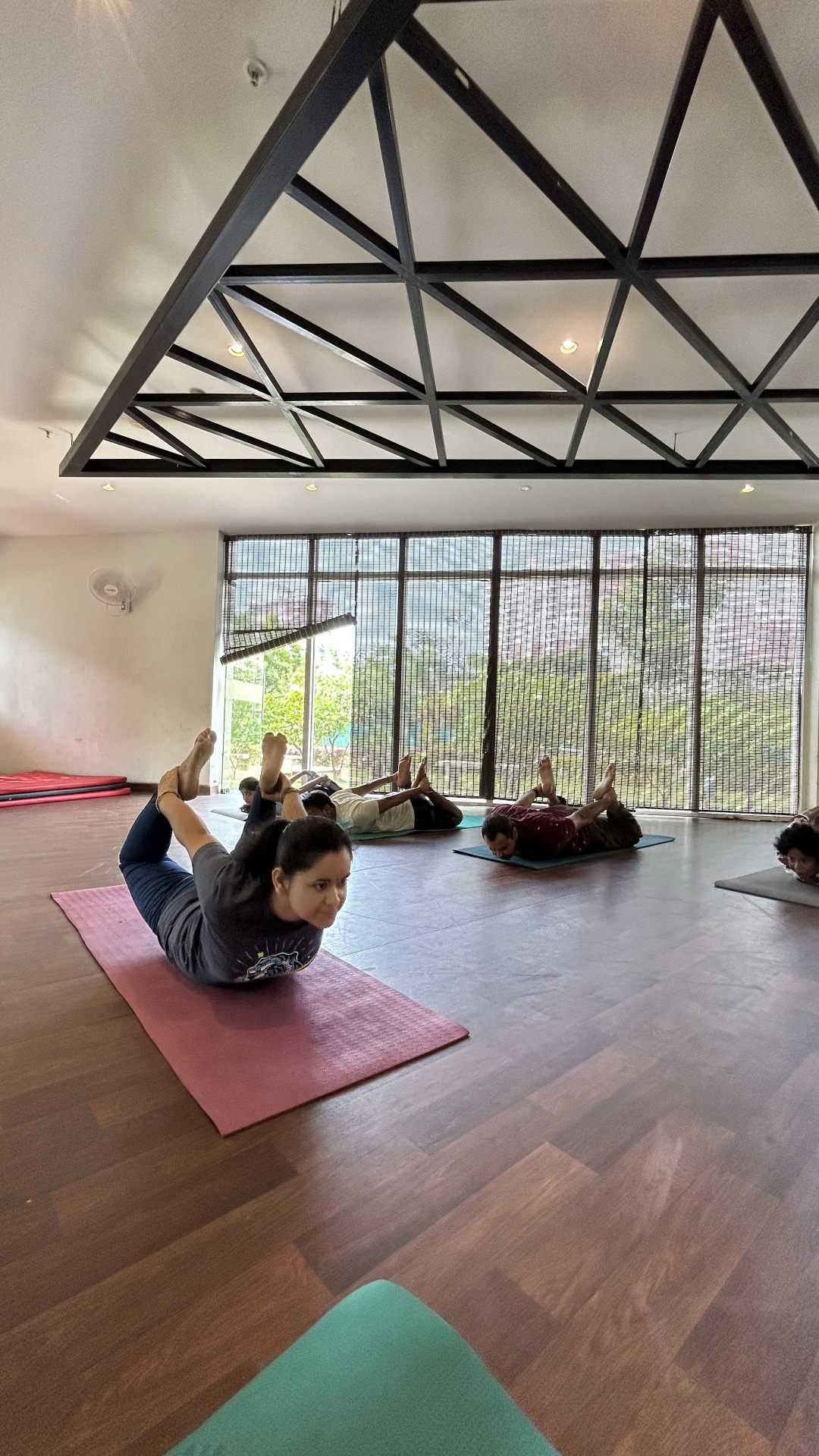 Practitioners in Shalabhasana (locust pose) during a group class