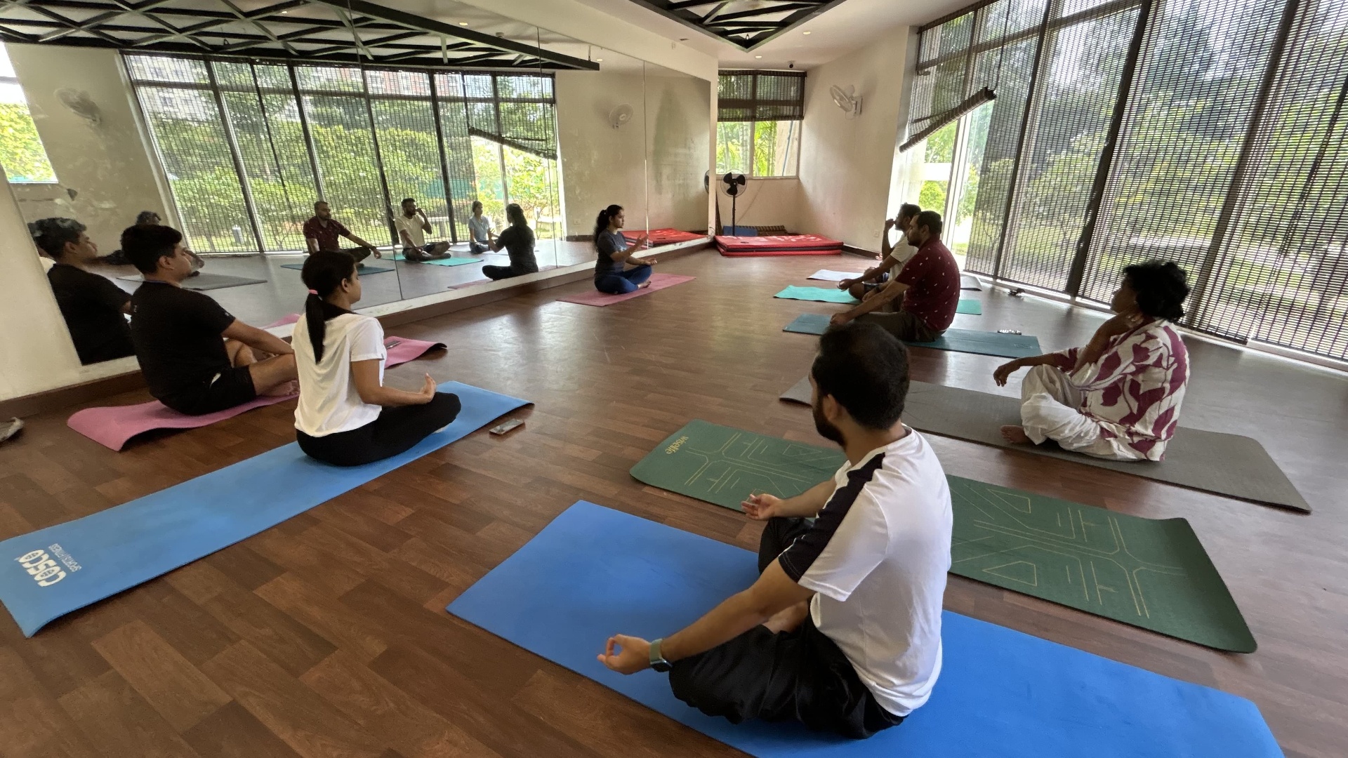Students seated in meditation, hands resting in chin mudra